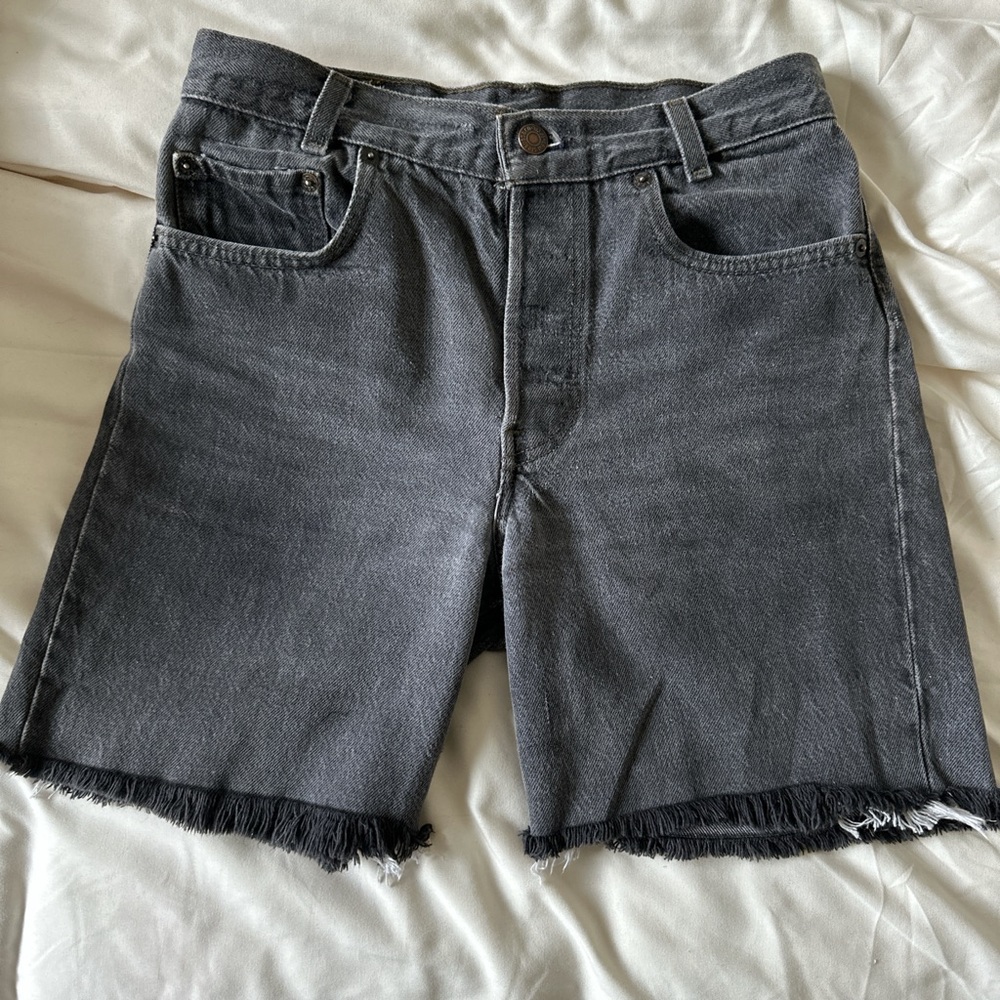 vintage levi’s 501 90s longline black denim shorts with frayed hem.